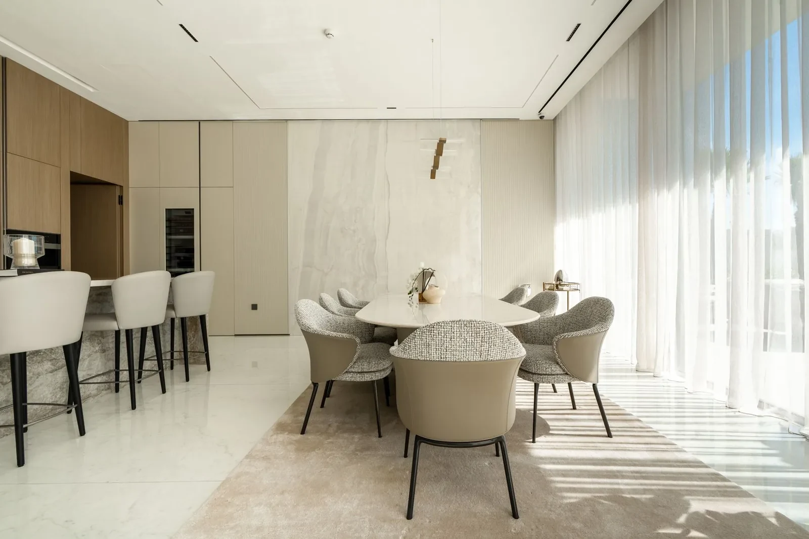 Dining area with a handcrafted curved chandelier at Villa Alma
