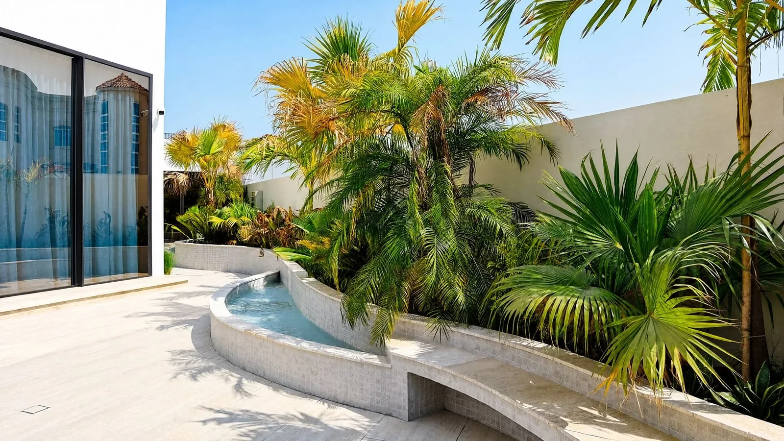 Lush planting beside a curved water feature at Villa Cielo