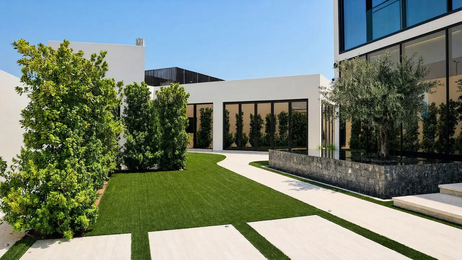 Lawn and stone pathway in the family garden at Villa Cielo